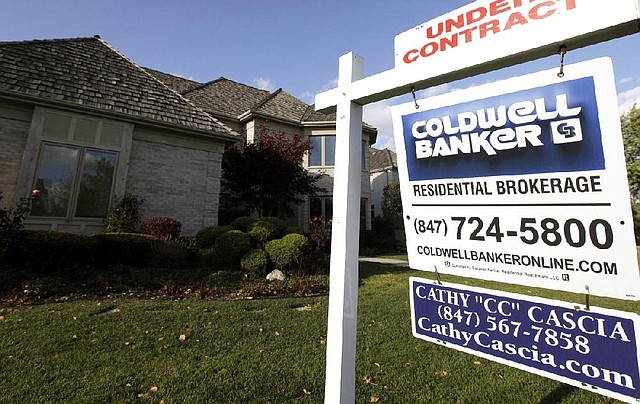 A Realtor’s sign marks a house under contract in Glen., Ill., in October. 