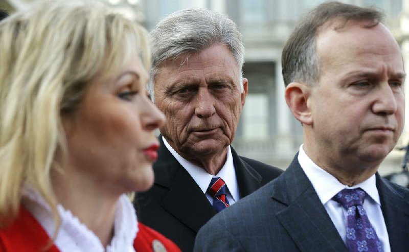 Arkansas Gov. Mike Beebe (center), a National Governors Association Executive Committee member, listens as the association’s vice chairman, Oklahoma Gov. Mary Fallin (left), and the association’s chairman, Delaware Gov. Jack Markell, talk to reporters Tuesday outside the West Wing of the White House in Washington. 