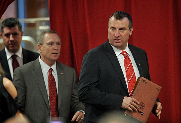 Arkansas football coach Bret Bielema, right, and Arkansas athletics director Jeff Long walk into the Raymond Miller Room on Wednesday, Dec. 5, 2012, for a press conference announcing Bielema as the Razorbacks' football coach.