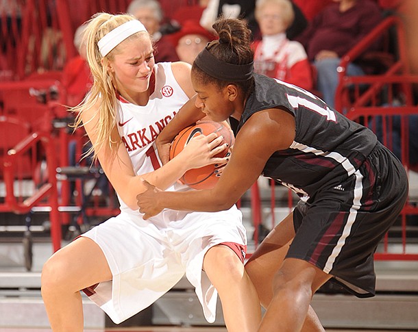 NWA Media / ANDY SHUPE -- Arkansas sophomore guard Calli Berna, left, and Texas Southern sophomore guard Janelle McQueen vie for a rebound during the first half of play Thursday, Nov. 29, 2012, in Bud Walton Arena.