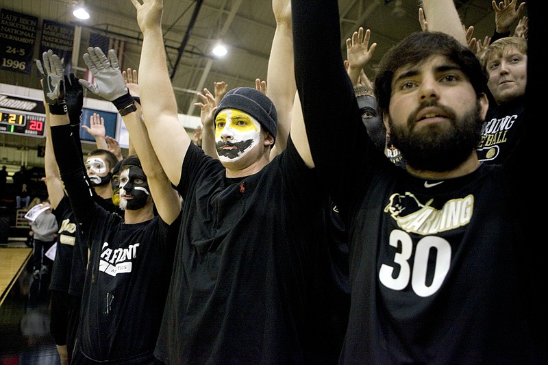 From the left, Luke Smith, Landon Hodnett and Will Lynn cheer for the Harding University men’s basketball team during its game against Northeastern (Okla.) State University. The Bisons defeated NSU 65-63 and are currently on a six-game win streak to start the season.
