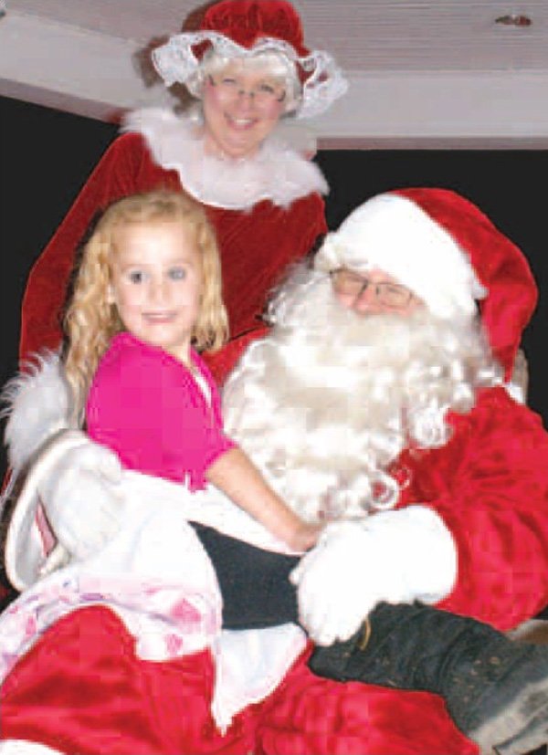 Bethany Crose showed her excitement while visiting with Santa and Mrs. Claus following the Gravette Christmas parade. Santa visited dozens of children in the band stand in Kindley Park. See next week's issue for Christmas Parade photos. 