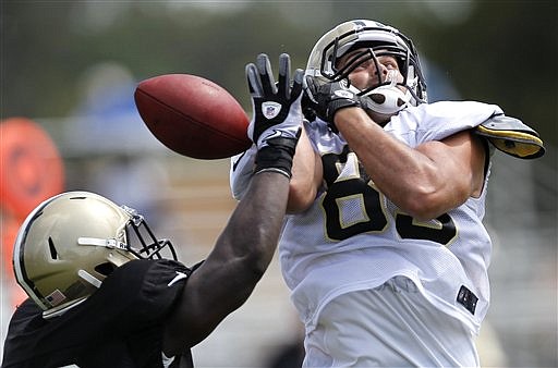 New Orleans Saints linebacker Lawrence Wilson, left, breaks up a pass intended for tight end Jake Byrne (82) during NFL football training camp in Metairie, La., Wednesday, Aug. 1, 2012. (AP Photo/Gerald Herbert)