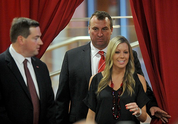 Arkansas football coach Bret Bielema follows his wife, Jen, into the Raymond Miller Room on Wednesday at Donald W. Reynolds Razorback Stadium. 