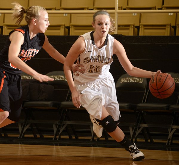 Bentonville’s Taylor Lee, right, drives to the basket during the Lady Tigers’ game Dec. 1. 