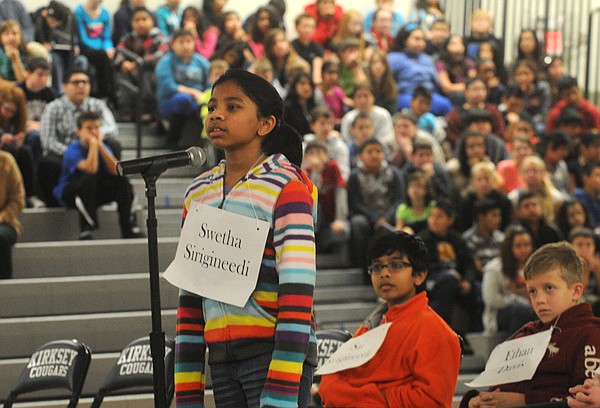 Swetha Sirigineedi answers a question during the Kirksey Middle School Geography Bee held Wednesday in the school gym. Swetha won the bee by knowing which state Kodiak Island is near. Ethan Davis, right, placed second and Swetha’s brother, Sai Sirigineedi, took third. All three are in the seventh grade at Kirksey. 