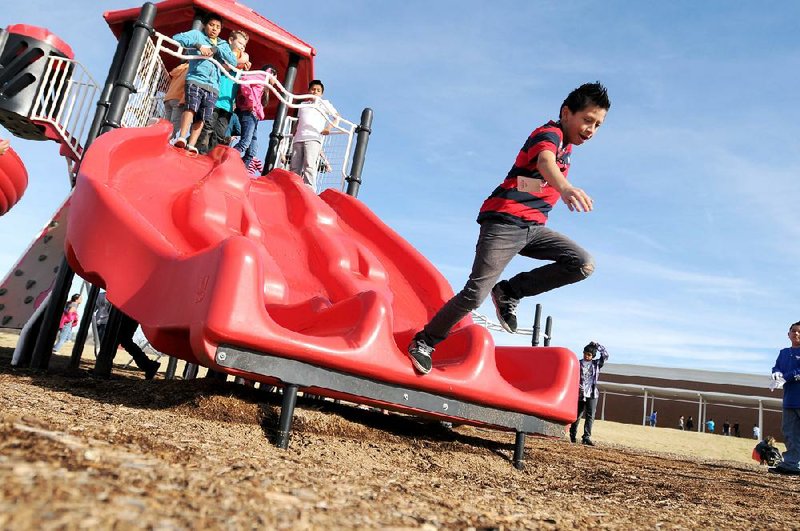 NWA Media/ANTHONY REYES
Tristen Lopez, 11, leaps from the slide Wednesday Dec. 5, 2012 during recess at Harp Elementary in Springdale.  The Springdale Coordinated Health group will discuss whether children playing before lunch encourages them to eat better.