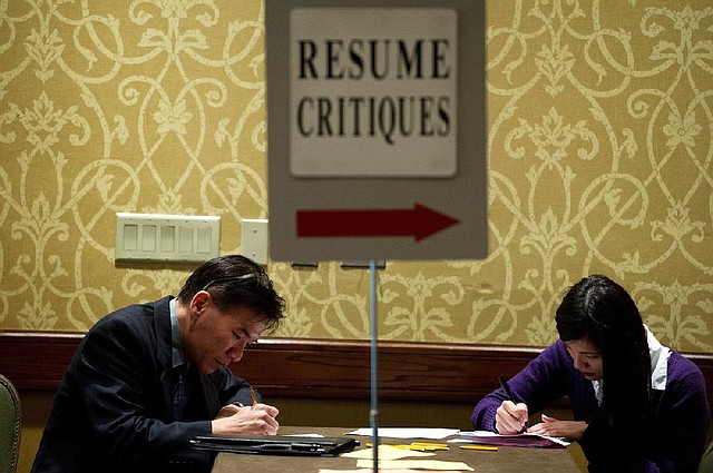 Job seekers fill out applications Tuesday at a job fair in San Jose, Calif. Nationally, applications for unemployment benefits fell last week to a seasonally adjusted 370,000. 