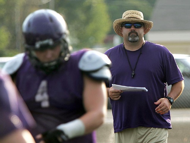 Ozark Coach Jeremie Burns (right) never played in a state championship game while he was in high school, but he’ll finally get a shot at the big game Saturday when he leads the Hillbillies against Stuttgart. 