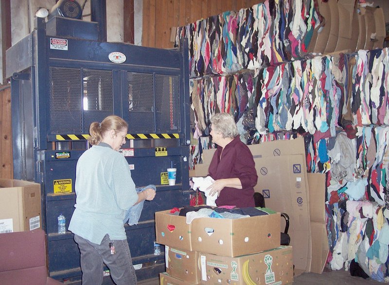 Kellie Traylor, left, and Nell Harrelson work the vertical baler at the Stone County Recycling Center, which collected more than 1 million pounds of recyclable material in 2011. 