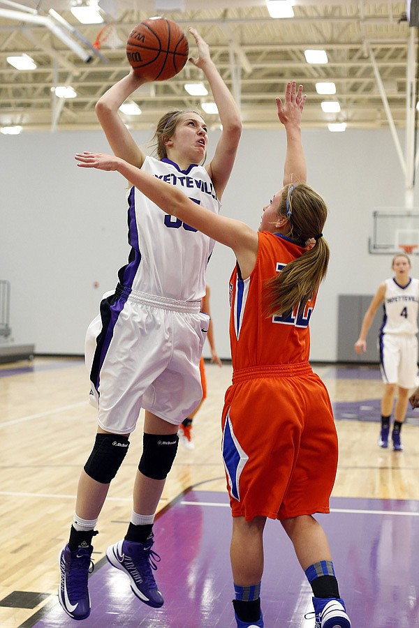 Lauren Schuldt, left, a Fayetteville sophomore forward, takes a shot in the lane over Springfield sophomore guard Kelsie Cleeton on Thursday during play at Fayetteville. 