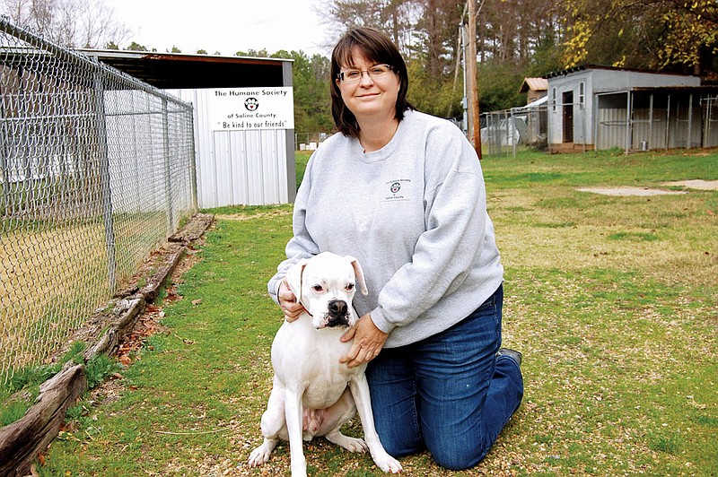 Ann Sanders, president of the Humane Society of Saline County in Bauxite, enjoys showing off her own dog, a boxer named Charlie, whom she adopted from the society’s shelter. Sanders and the shelter are looking for homes for 23 cats and almost 30 dogs. They would like to reduce the population at the shelter so the animals can be kept indoors during the winter.