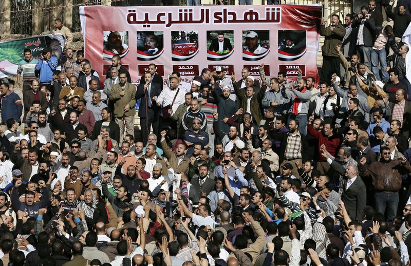 Muslim Brotherhood and Egyptian President Morsi supporters chant slogans during the funeral of three victims who were killed during Wednesday's clashes outside Al-Azhar mosque, the highest Islamic Sunni institution, on Friday, Dec. 7, 2012. 