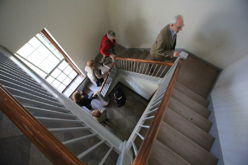 Jeff Baskin (right), executive director of the William F. Laman Public Library System, leads members of the North Little Rock Chamber of Commerce upstairs in the old post office on Main Street in North Little Rock. The library purchased the building in September and plans to renovate it to serve as its Argenta branch library, currently housed in the city’s old fire station nearby. 