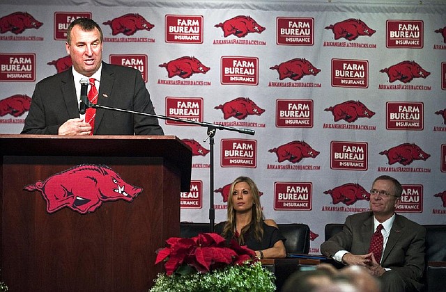 New Arkansas head coach Bret Bielema, left, speaks during an NCAA college football news conference in Fayetteville, Ark., Wednesday, Dec. 5, 2012. At center and right are Bielema's wife Jen and athletic director Jeff Long. Bielema, who will be paid $3.2 million annually for six years, replaces interim coach John L. Smith, who was hired after Bobby Petrino was fired in April. (AP Photo/April L. Brown)