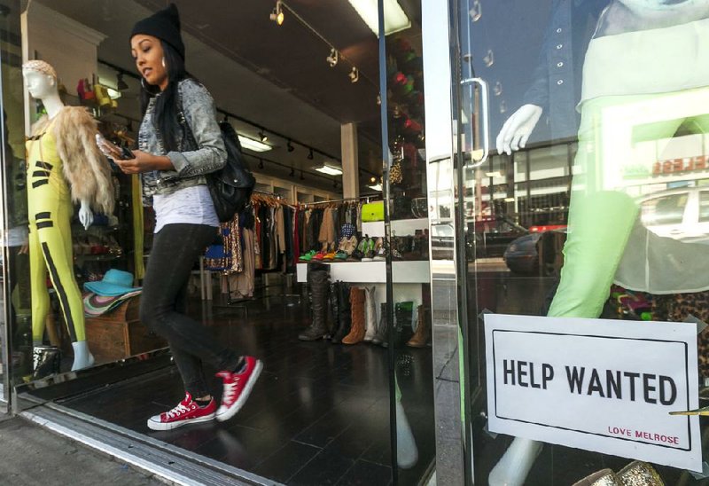 A clothing boutique advertises for workers Friday in Los Angeles. Since July, the economy has added an average of 158,000 jobs a month. 