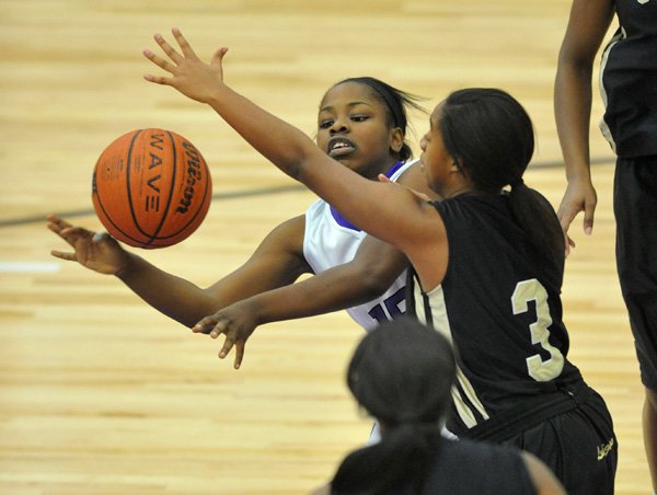 Denesha White, Fayetteville, tries to pass the ball Friday around Little Rock Central defender Taylor Lewis during the Lady Bulldog Classic tournament in Fayetteville. 