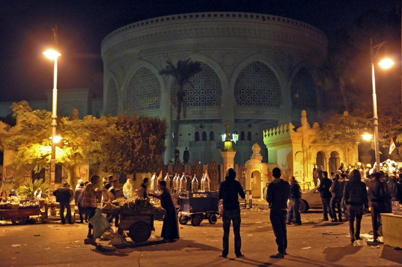 Vendors provide demonstrators with food and drink outside the presidential palace, after tens of thousands marched on the presidential palace pushing past barbed wire fences installed by the army, in Cairo, Egypt. during the early hours of Saturday, Dec. 8, 2012. Egypt postponed early voting on a contentious draft constitution, and aides to President Mohammed Morsi floated the possibility of canceling the whole referendum in the first signs Friday that the Islamic leader is finally yielding to days of protests and deadly street clashes.