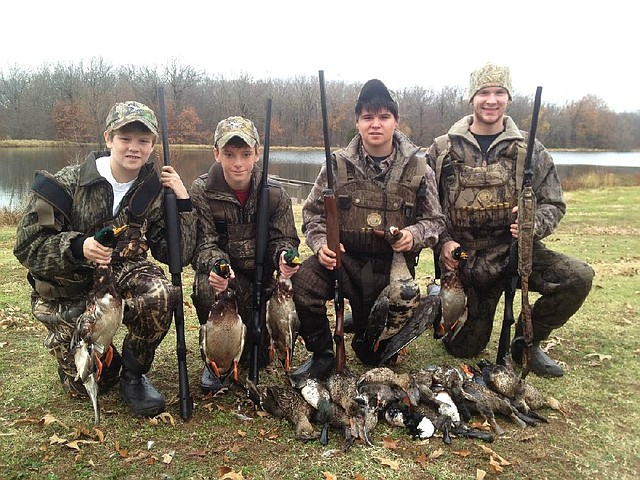 A buckbrush reservoir near Stuttgart provided a stellar duck hunt Thursday for (from left) Ely Caroom, Jack Ferguson, Fischer Hutchison and Preston Clark. 