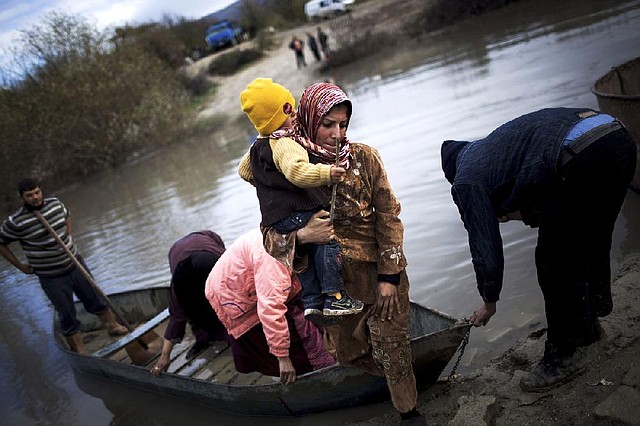 Syrian refugees cross the Orontes River into Turkey on Saturday. Turkey is among several nations that have recognized the Syrian rebels’ National Alliance. 