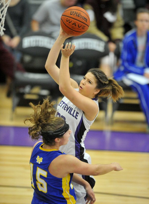 Sydney Crockett of Fayetteville High drives to the hoop past Mountain Home defender Katie Kapler during the first half of Saturday’s game at the Lady Bulldog Classic at Fayetteville High School. 