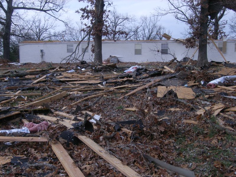 The rooftop remains of a duplex west of Viola are shown scattered throughout a field and in the trees after strong winds and a possible tornado tore through the area Sunday afternoon.