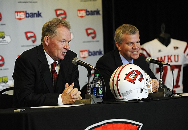 New Western Kentucky head coach Bobby Petrino, left, speaks with athletic director Todd Stewart during an NCAA college football news conference, Monday, Dec. 10, 2012, in Bowling Green, Ky. The 51-year-old was fired by Arkansas in April for a "pattern of misleading" behavior following an accident in which the coach was injured while riding a motorcycle with his mistress as a passenger but now wants to make the most of his second chance. (AP Photo/The Daily News, Joe Imel)