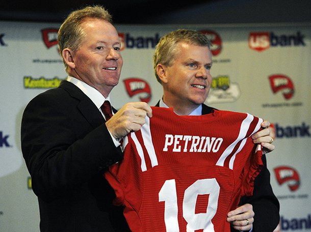 New Western Kentucky head coach Bobby Petrino, left, holds up a jersey with athletic director Todd Stewart during an NCAA college football news conference, Monday, Dec. 10, 2012, in Bowling Green, Ky. The 51-year-old was fired by Arkansas in April for a "pattern of misleading" behavior following an accident in which the coach was injured while riding a motorcycle with his mistress as a passenger but now wants to make the most of his second chance. (AP Photo/The Daily News, Joe Imel)