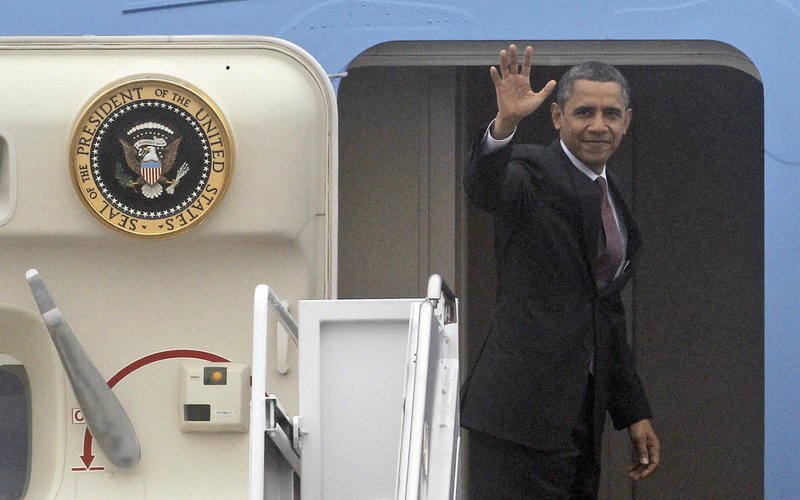 President Barack Obama waves as he boards Air Force One at Andrews Air Force Base, Md., on Monday, Dec. 10, 2012, before departing for Michigan.