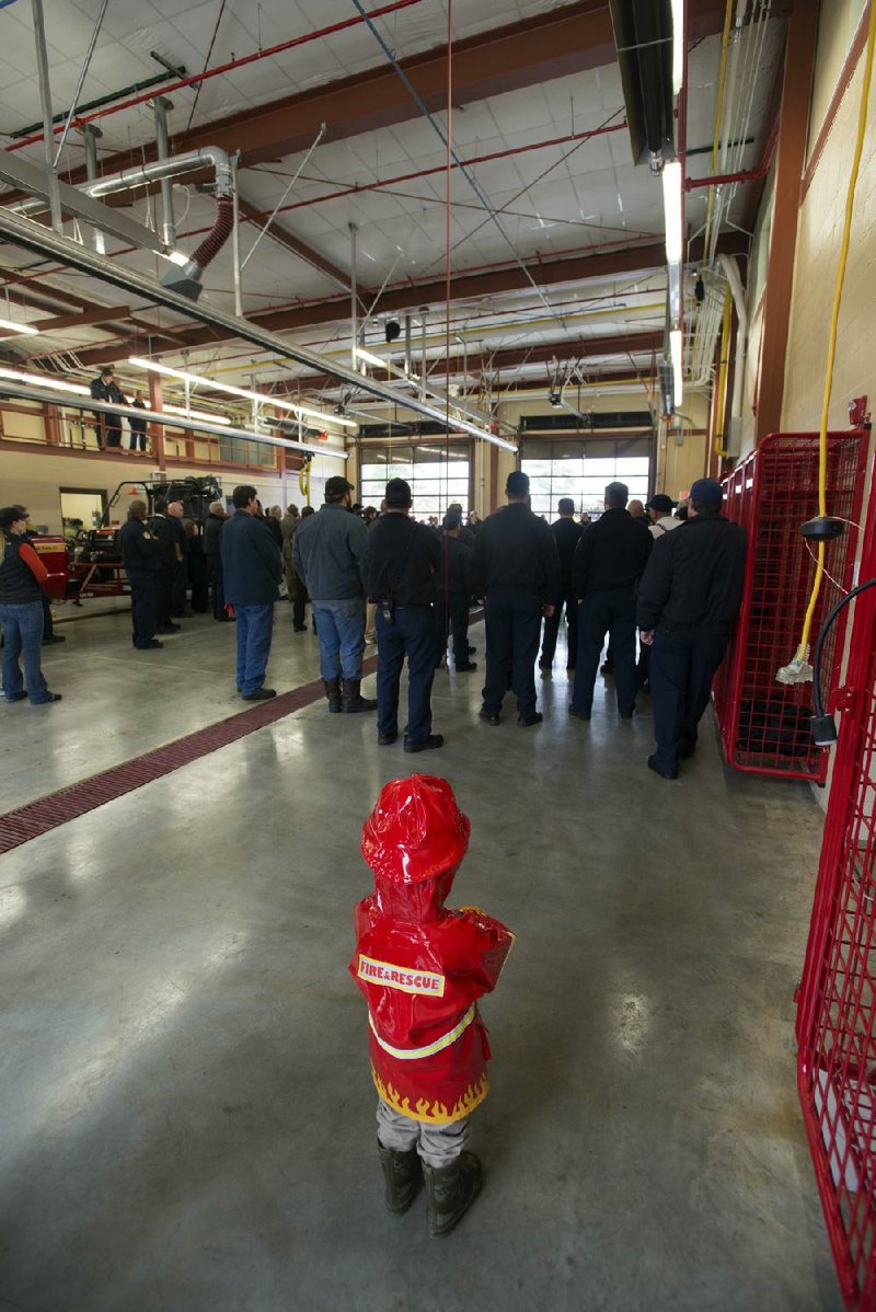 Henry Wall, 3, watches the dedication of the new Little Rock Fire Department ÿre station No. 23 at 4500 Rahling Road in Little Rock on Monday morning.