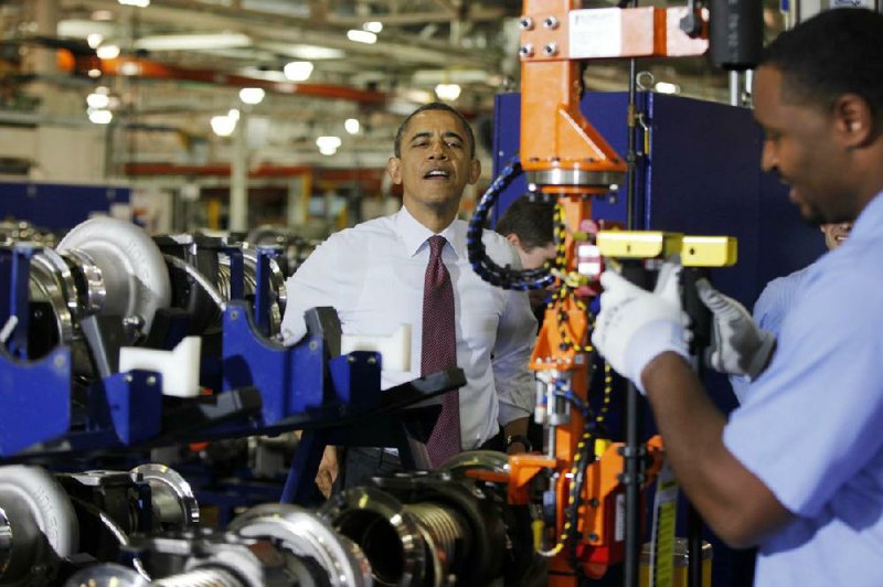 President Barack Obama watches a worker during a visit Monday to the heavy-duty-engine line at the Daimler Detroit Diesel plant in Redford, Mich. 