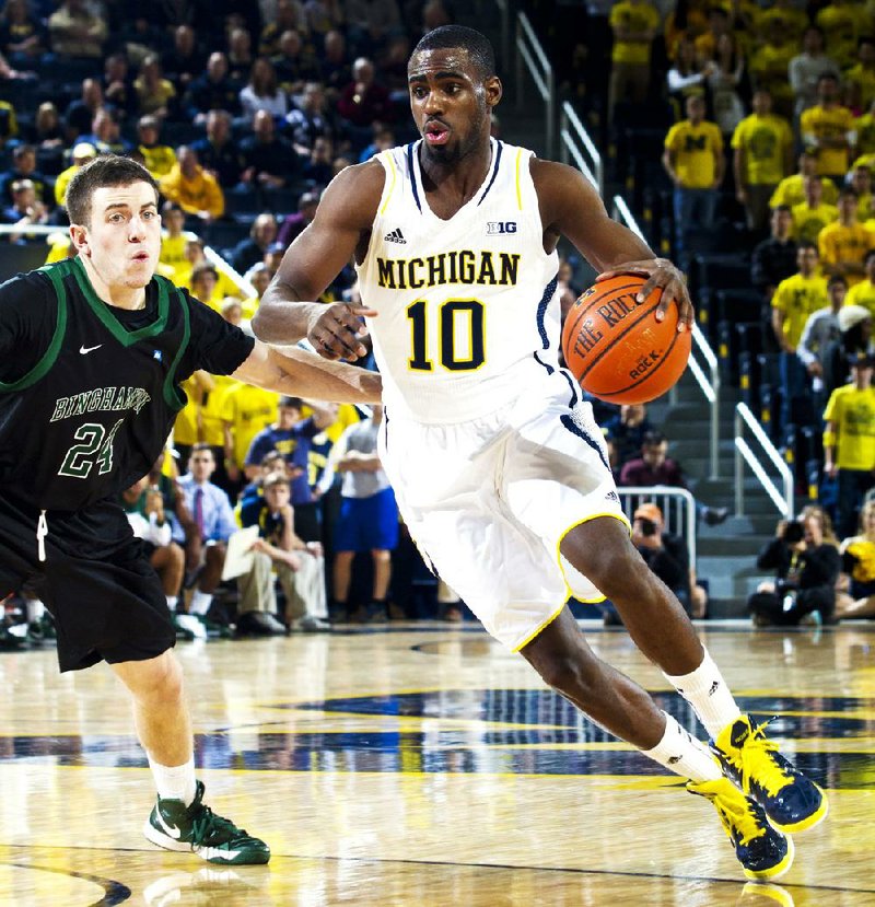 Michigan guard Tim Hardaway Jr. (right) drives against Binghamton guard Mike Horn on Tuesday in the second half of the No. 3 Wolverines’ 67-39 victory in Ann Arbor, Mich. 