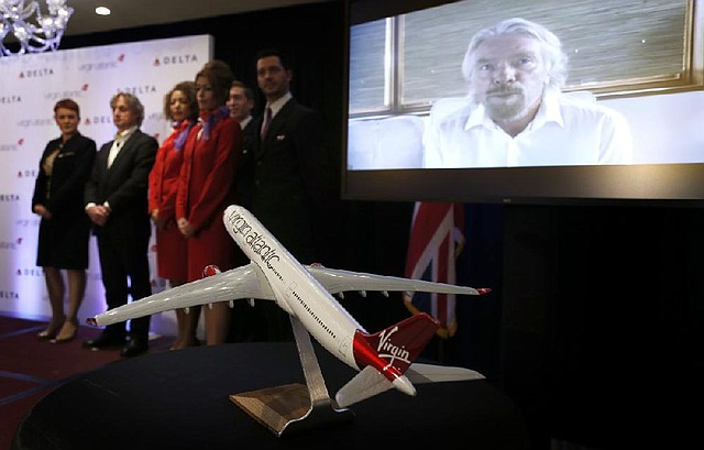 Virgin Group founder and Chairman Sir Richard Branson speaks via a videoconference link Tuesday as Delta Air Lines announced it will buy nearly half of Virgin Atlantic Airways to give it a bigger stake in the New York-to-London air-travel market. 