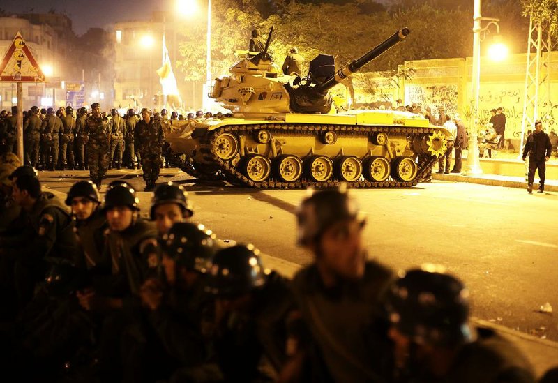 An Egyptian army tank deploys as Egyptian protesters gather outside the presidential palace during a demonstration against President Mohammed Morsi in Cairo on Tuesday. 