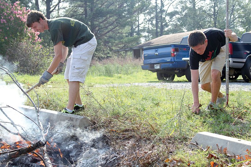 Kappa Sigma brothers Sean O’Toole, left, and Jon-Michael Poff clean up brush at the Batesville Community Theatre during Lyon College’s annual Service Day in September. The school ranks second in the nation in fraternity participation.