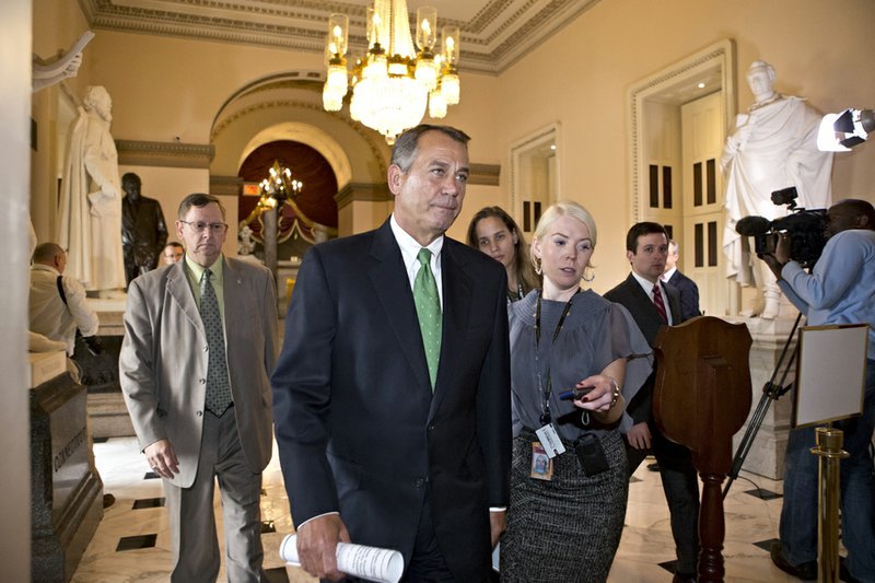 House Speaker John Boehner of Ohio walks to the House floor to deliver remarks about negotiations with President Barack Obama on the fiscal cliff on Tuesday, Dec. 11, 2012, on Capitol Hill in Washington. 