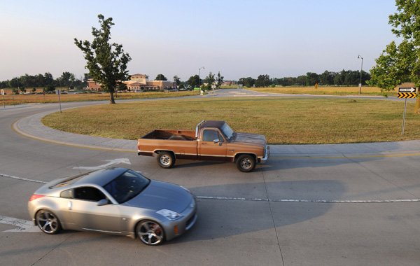 Drivers travel through a roundabout in Rogers on May 25 on Whitaker Parkway, west of Exit 82 on Intertate 540. 