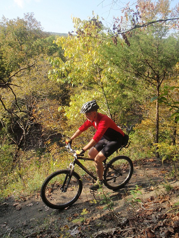 Tim Scott, assistant superintendent at Devil’s Den State Park pedals in October along the Fossil Flats Trail. Parts of the trail have been rerouted for easier riding. The project added about one-half mile to the trail. 