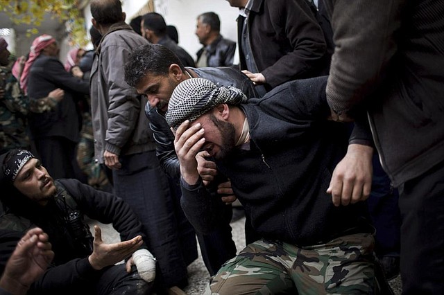 A rebel fighter grieves Thursday during a funeral in Azaz for a comrade killed by Syrian forces. 