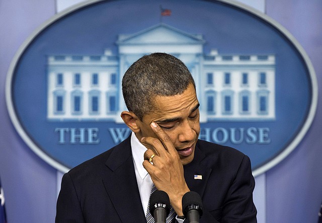 President Barack Obama wipes his eye as he talks about the Connecticut elementary school shooting, Friday, Dec. 14, 2012, in the White House briefing room in Washington.
