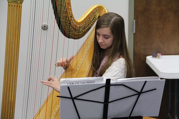 Emily Carpenter, a Central Junior High School student, performed Oct. 30 on harp at a school board luncheon at Central Junior High School in Springdale.