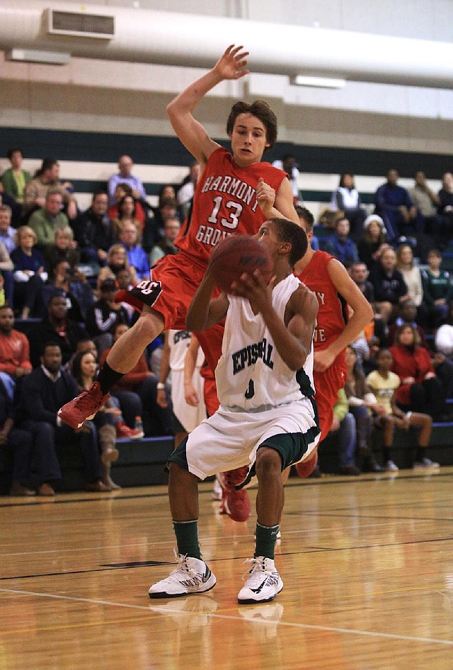 Episcopal Collegiate freshman Allie Freeman (left) tries to shoot past Benton Harmony Grove’s Larry McMurray during Friday’s game in Little Rock. Freeman ÿnished with seven points as Episcopal won 45-31. 