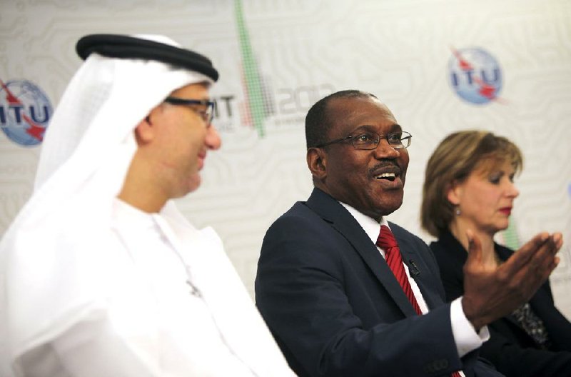 Hamadoun Toure, secretary-general of the International Telecommunications Union, (center) answers questions Friday at a news conference in Dubai, United Arab Emirates. 
