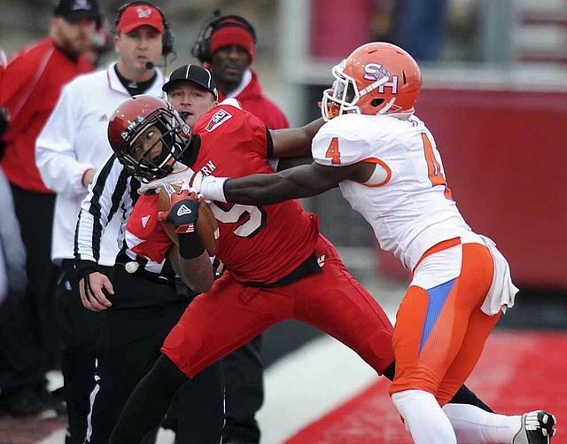 Sam Houston State’s Bookie Sneed knocks Eastern Washington’s Shaquille Hill out of bounds during Saturday’s FCS playoff game. 