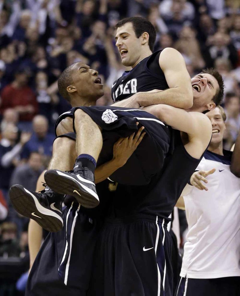 Butler guard Alex Barlow (center) celebrates with forward Kameron Woods (left) and center Andrew Smith after Butler defeated No. 1 Indiana 88-86 in overtime Saturday in Indianapolis. Barlow hit the game-winning shot to give unranked Butler the upset. 