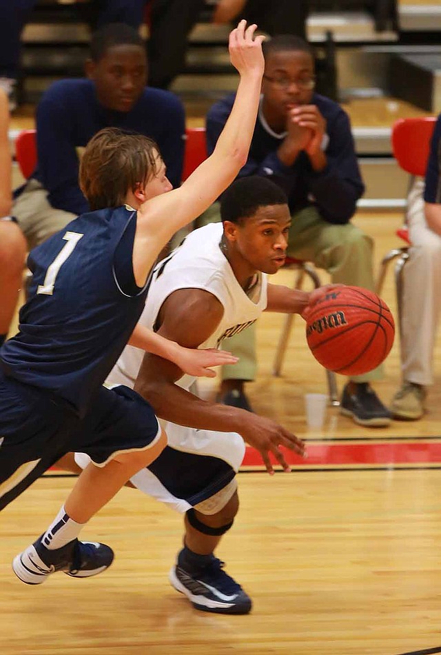 Pulaski Academy’s Brandon Brady (15) drives to the basket against Shiloh Christian defender Hunter Pauling during the Bruins’ 71-63 victory over the Saints on Saturday at the Arkansas Hoops Challenge in Maumelle. 