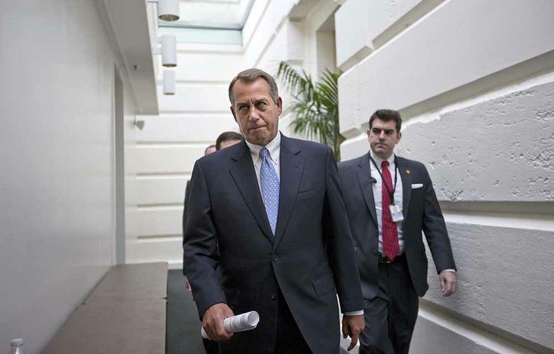 FILE - In this Dec. 5, 2012, file photo, House Speaker John Boehner of Ohio walks to a closed-door Republican strategy session, Wednesday, Dec. 5, 2012, on Capitol Hill in Washington. Boehner has been caught up in a monumental struggle over taxes and spending aimed at keeping the country from taking a yearend dive over the "fiscal cliff." President Barack Obama is tugging Boehner one way in pursuit of a budget deal, while conservatives yank the other way, some howling that the speaker already is going wobbly on them and turning vindictive against those in his party who dare disagree.  