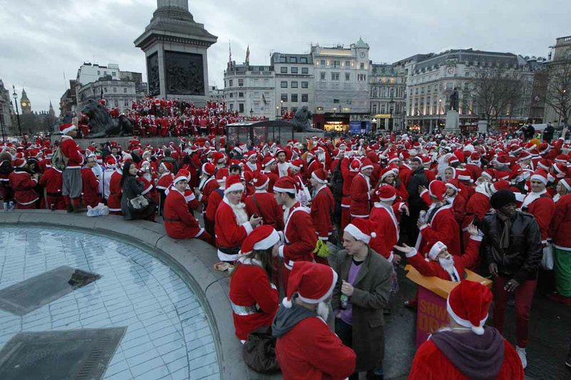 Revellers dressed up in Santa outfits gather at Trafalgar Square in London during a Santacon festival parade through the streets of London, Saturday, Dec. 15, 2012. 
