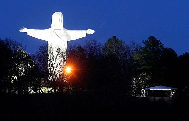 NWA Media/JASON IVESTER
Lights illuminate the Christ of the Ozarks statue on Sunday, Dec. 16, 2012, in Eureka Springs. After the lights were turned off -- the first time since 1967 -- following the closing of the Great Passion Play, donors helped bring the lights back on. The electric bill for the two 10,000-watt floodlights is about $200/month in the winter.