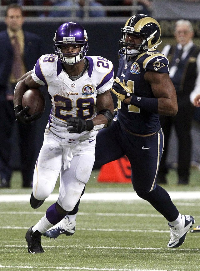Minnesota Vikings running back Adrian Peterson (left) had a season high 212 yards on 24 carries against the St. Louis Rams on Sunday. Peterson has 1,812 yards rushing, leaving him 294 shy of breaking the NFL’s single-season mark of 2,105 set by Eric Dickerson in 1984.


